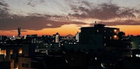 a cityscape at dusk with buildings in the background