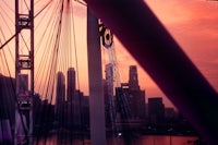 a city skyline is seen from the top of a ferris wheel